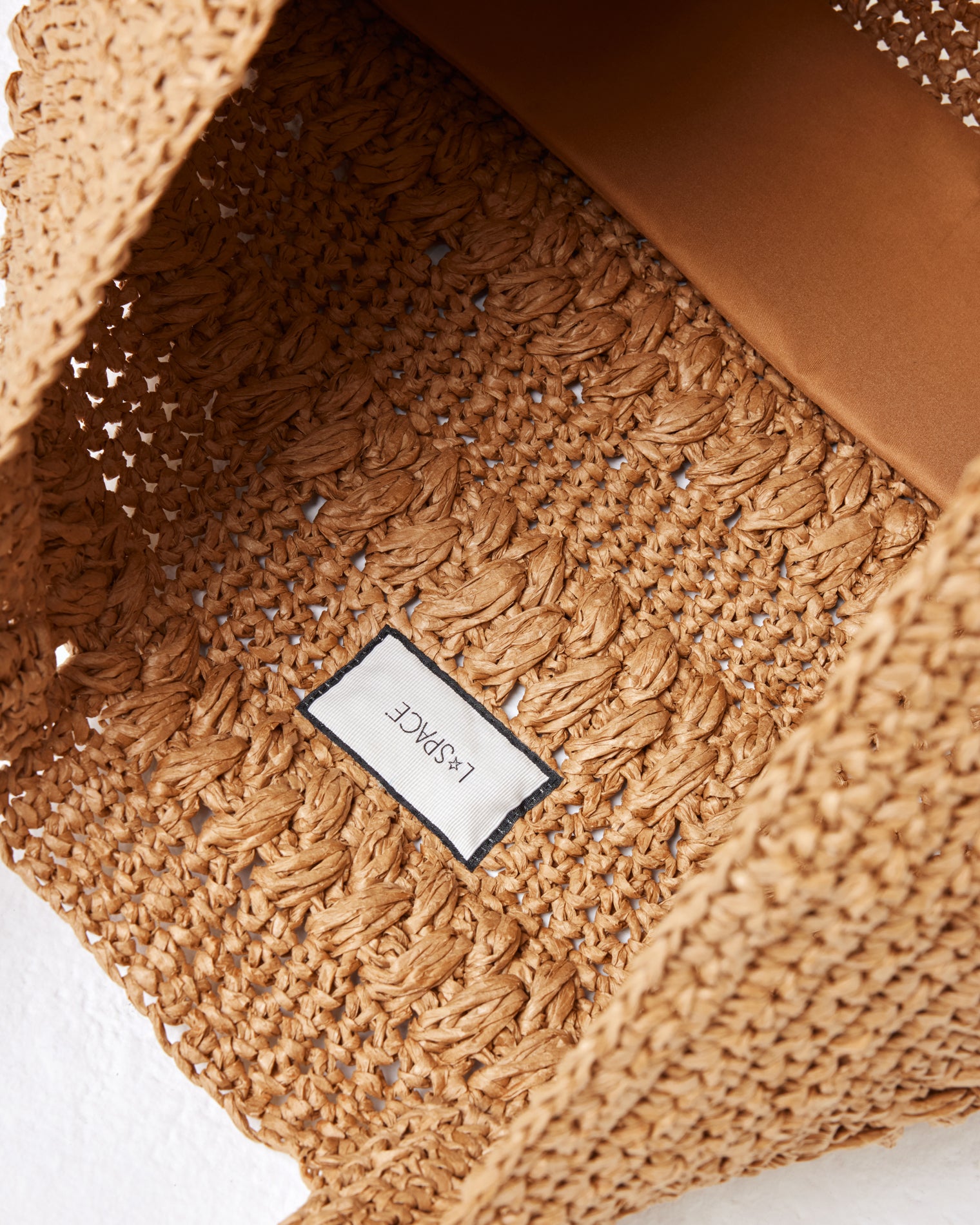 Changing Tides Bag - Natural Close-up interior view of the Changing Tides Bag in natural showing the LSPACE branding label.