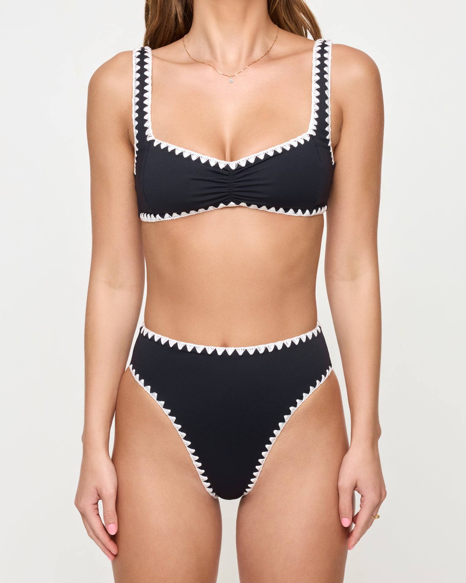 Effie Bikini Top - Black-Cream close up view of woman wearing a black bikini with white trim on a plain background