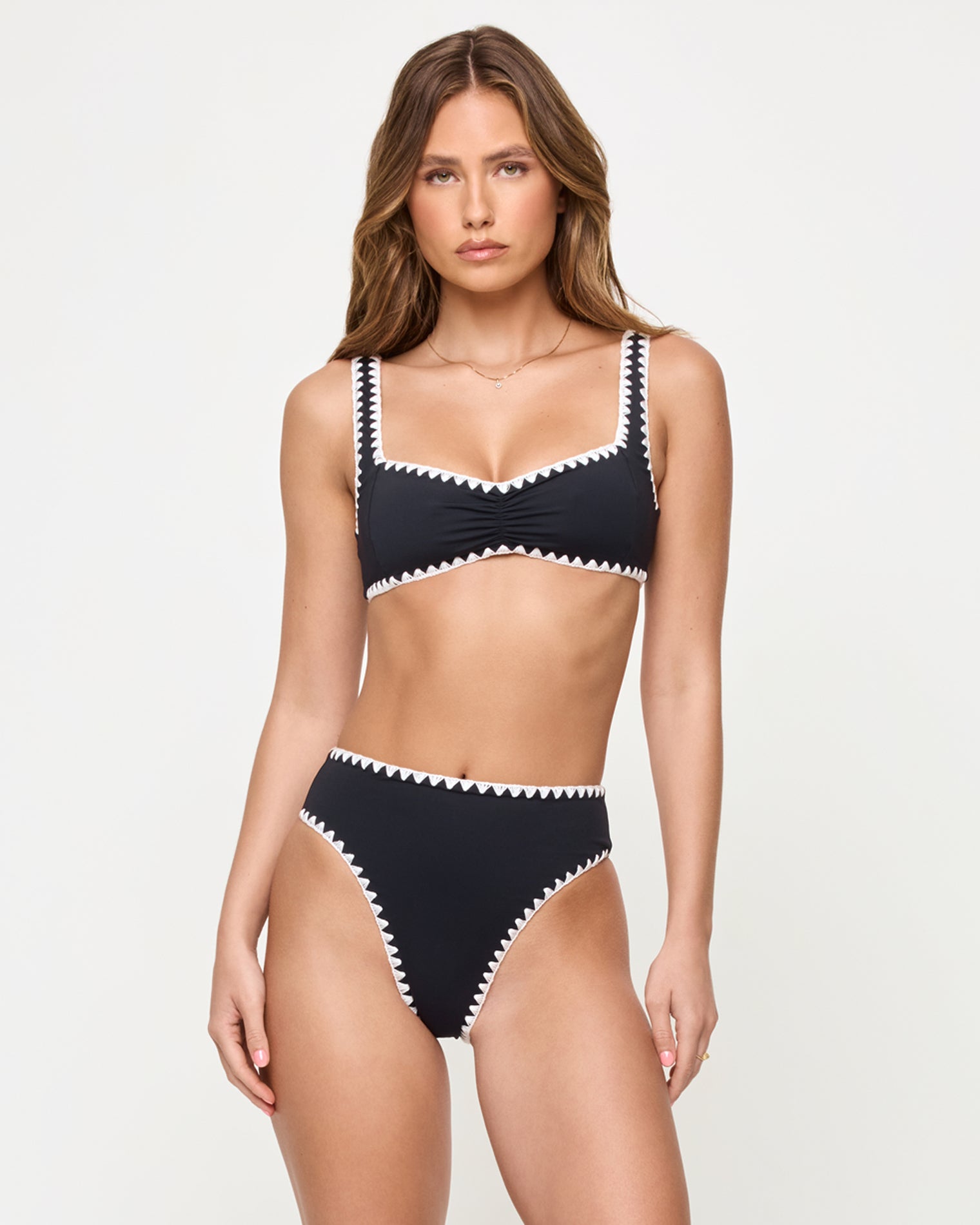 Effie Bikini Top - Black-Cream front view of woman wearing a black bikini with white trim on a plain background