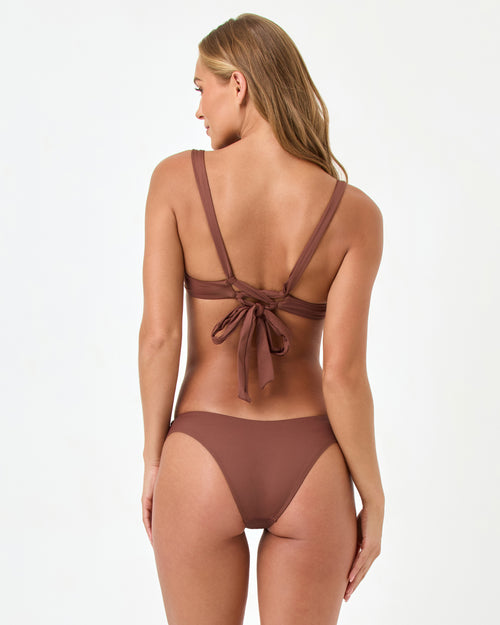 Back view of a model wearing the LSPACE Rocky Bikini Bottom and matching Mako Bikini Top with tie-back detail.
