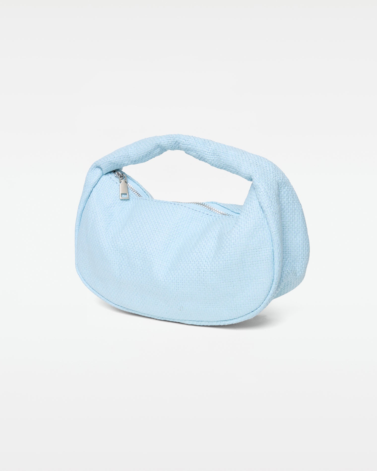 Mendoza Bag - Sky Blue Angled view of the Mendoza Bag in sky blue showing the woven texture, silver zipper closure, and curved handle.