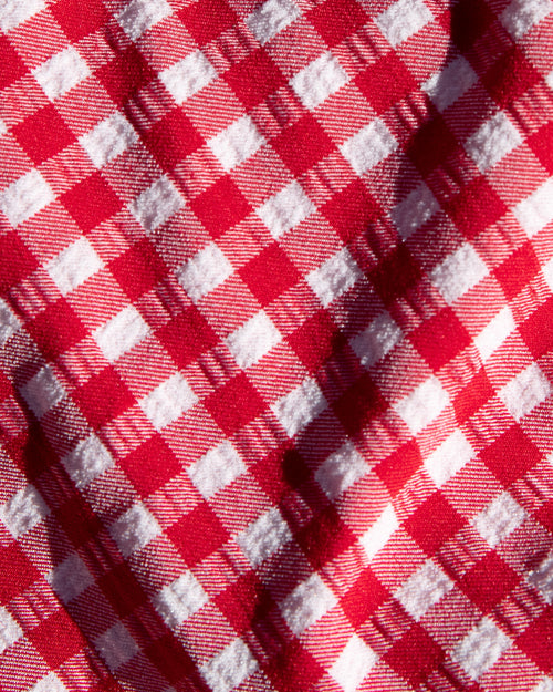 Close-up of red and white gingham check fabric used in the LSPACE lipstick red.