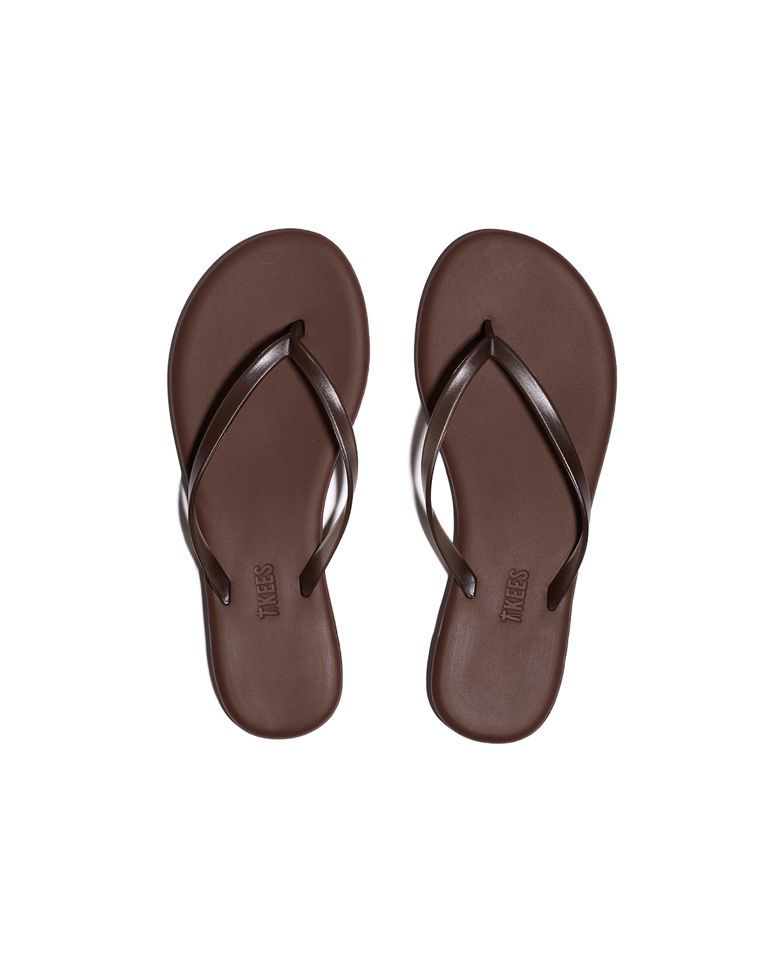 TKEES Aqua Sandals - Brown Top-down view of both brown TKEES Aqua Sandals with slim thong strap and TKEES logo on footbed.