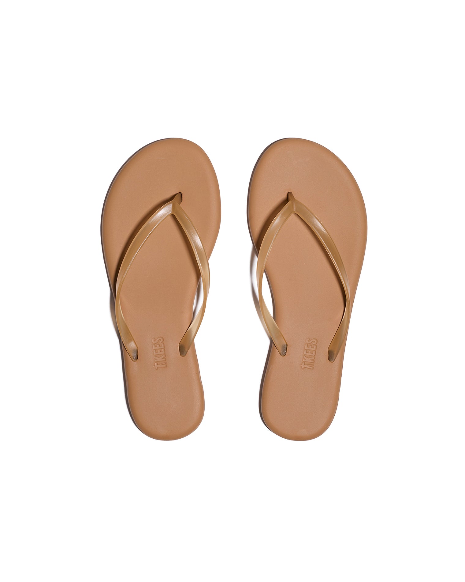 TKEES Aqua Sandals - Tan Top-down view of both tan TKEES Aqua Sandals with slim thong strap and TKEES logo on footbed.