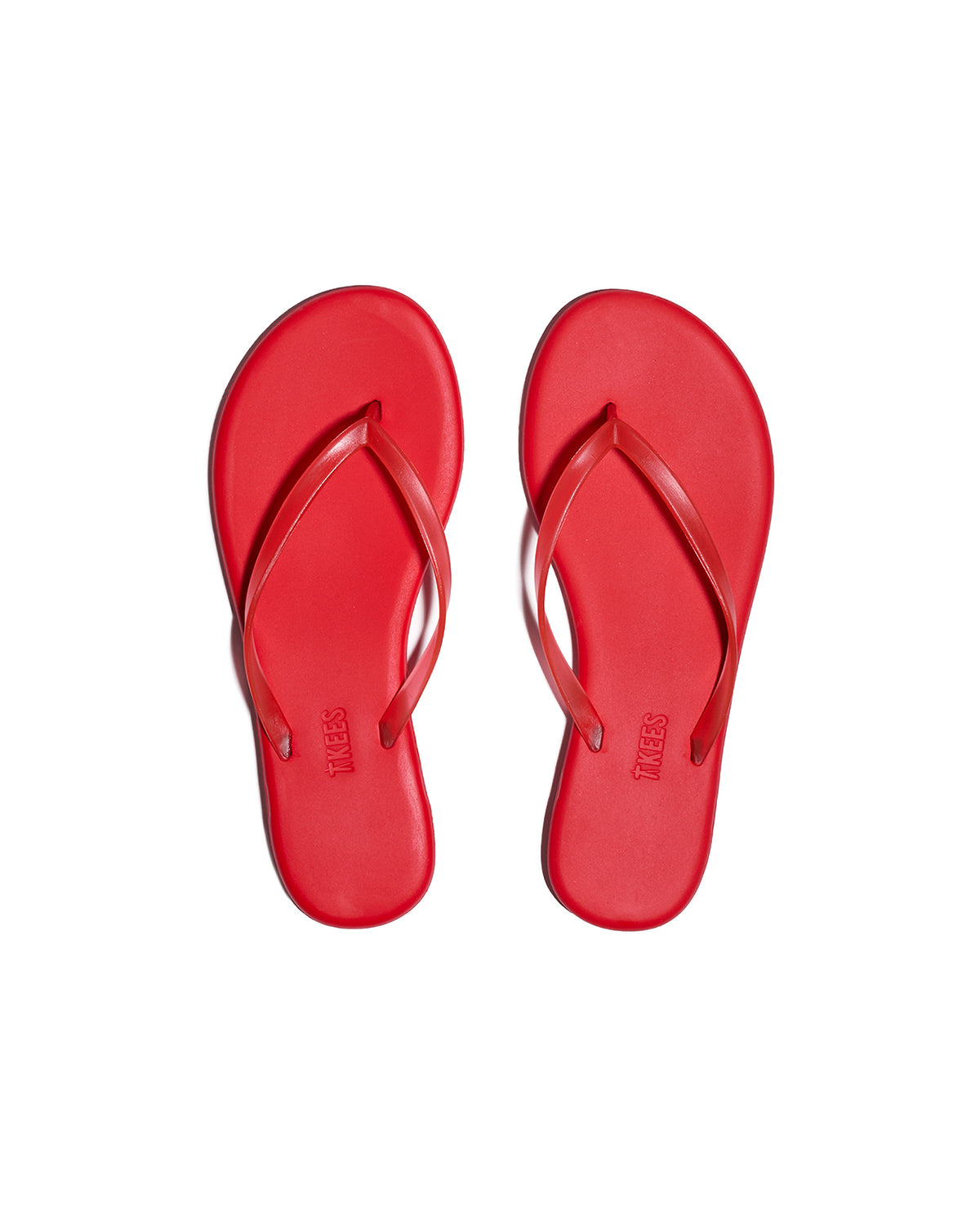 TKEES Aqua Sandals - Red Top-down view of both red TKEES Aqua Sandals with slim thong strap and TKEES logo on footbed.