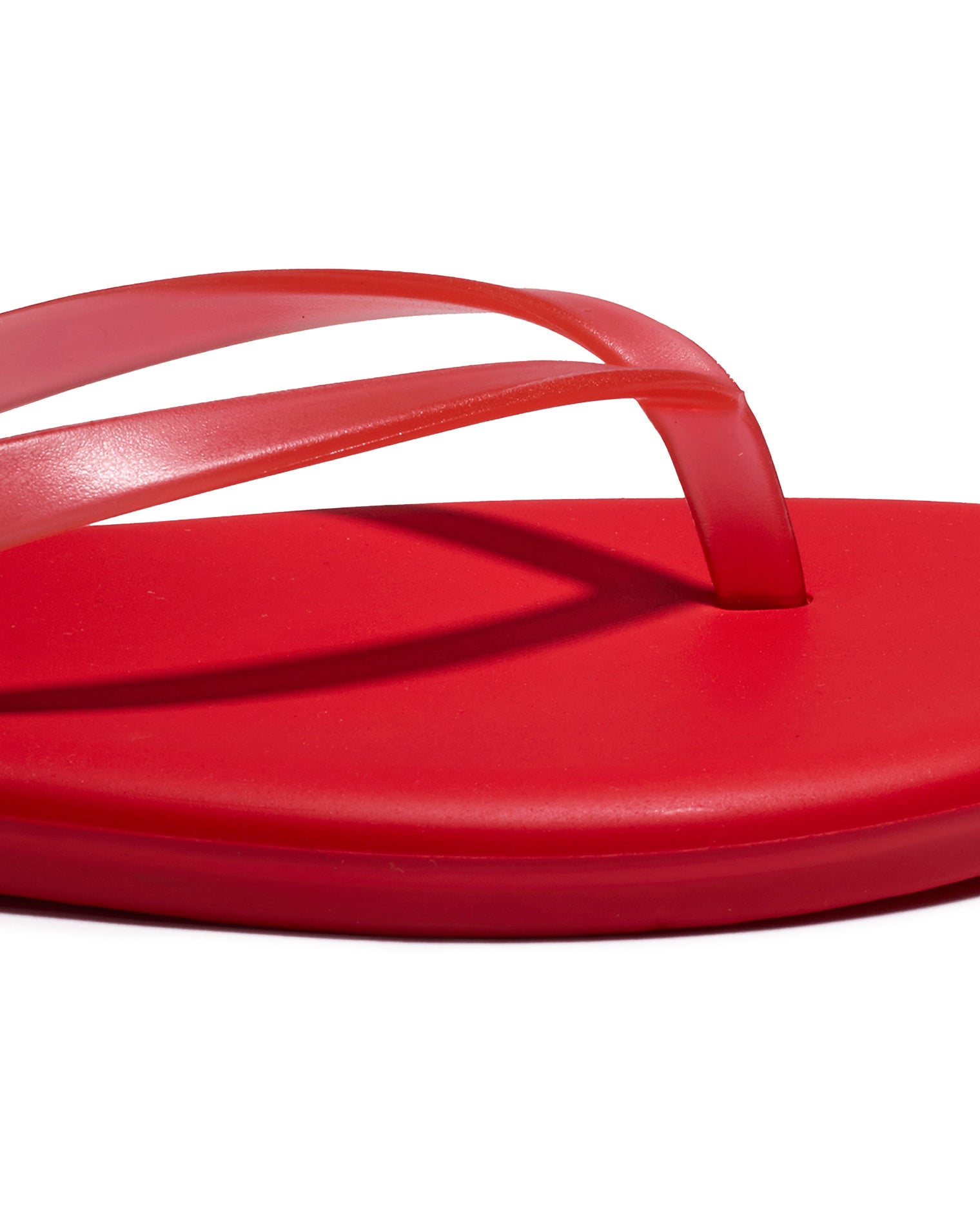 TKEES Aqua Sandals - Red Close-up of the red thong strap and footbed detail on the TKEES Aqua Sandals.