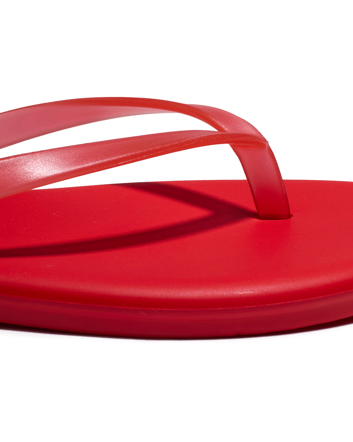 TKEES Aqua Sandals - Red Close-up of the red thong strap and footbed detail on the TKEES Aqua Sandals.
