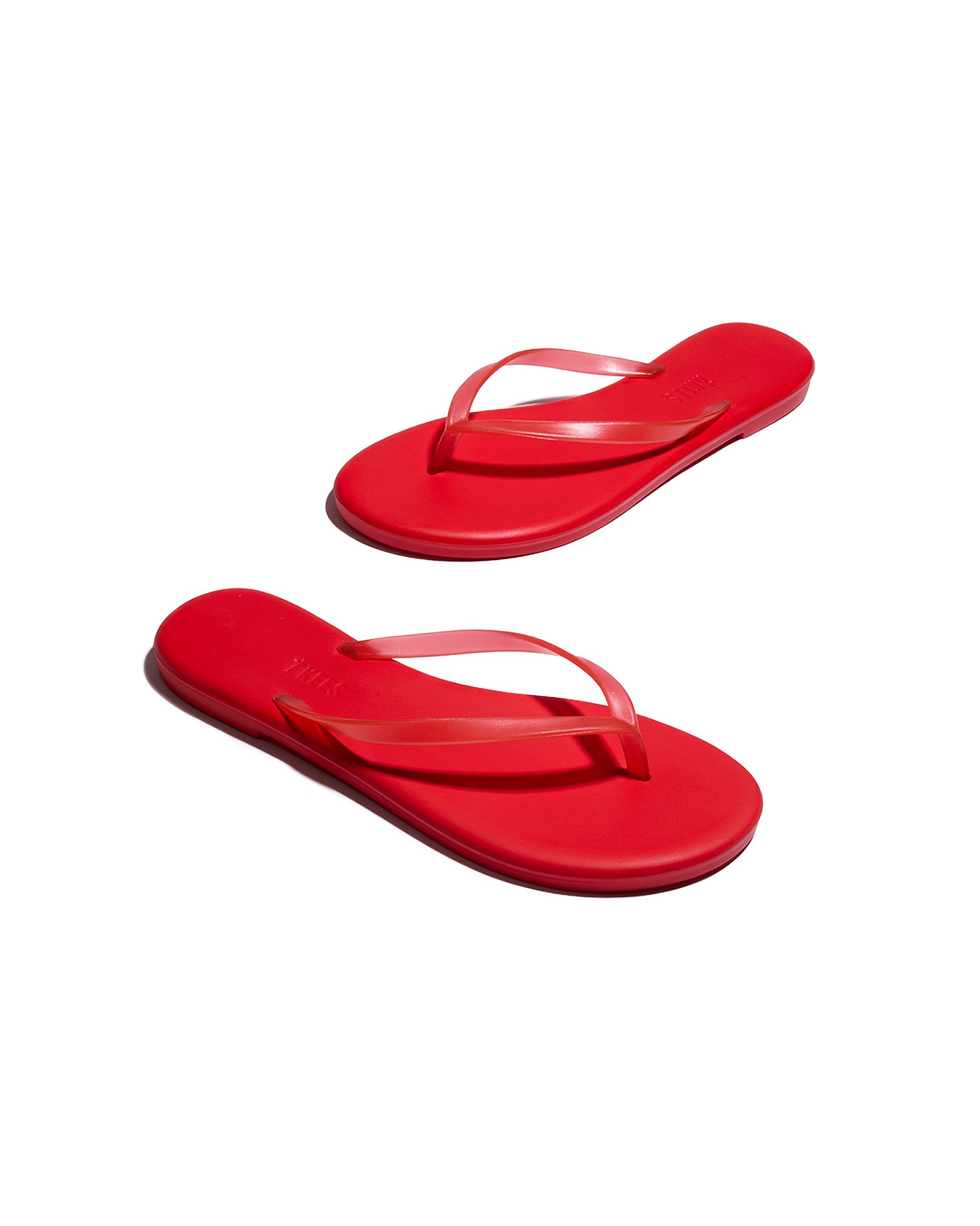TKEES Aqua Sandals - Red Angled view of both red TKEES Aqua Sandals showing the sole and side profile.