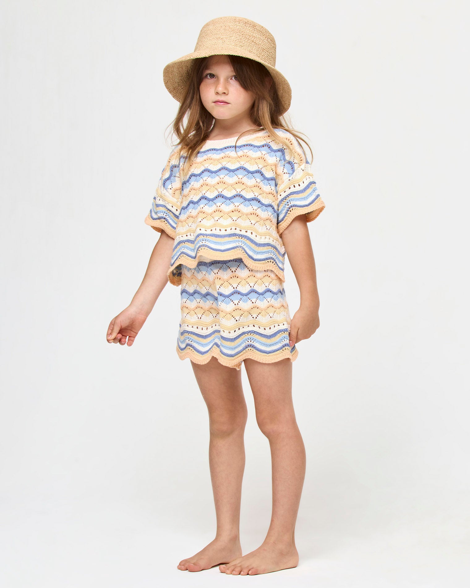 Isadora Mini Bucket Hat - Natural LSPACE Isadora mini bucket hat in natural, three-quarter view on model.