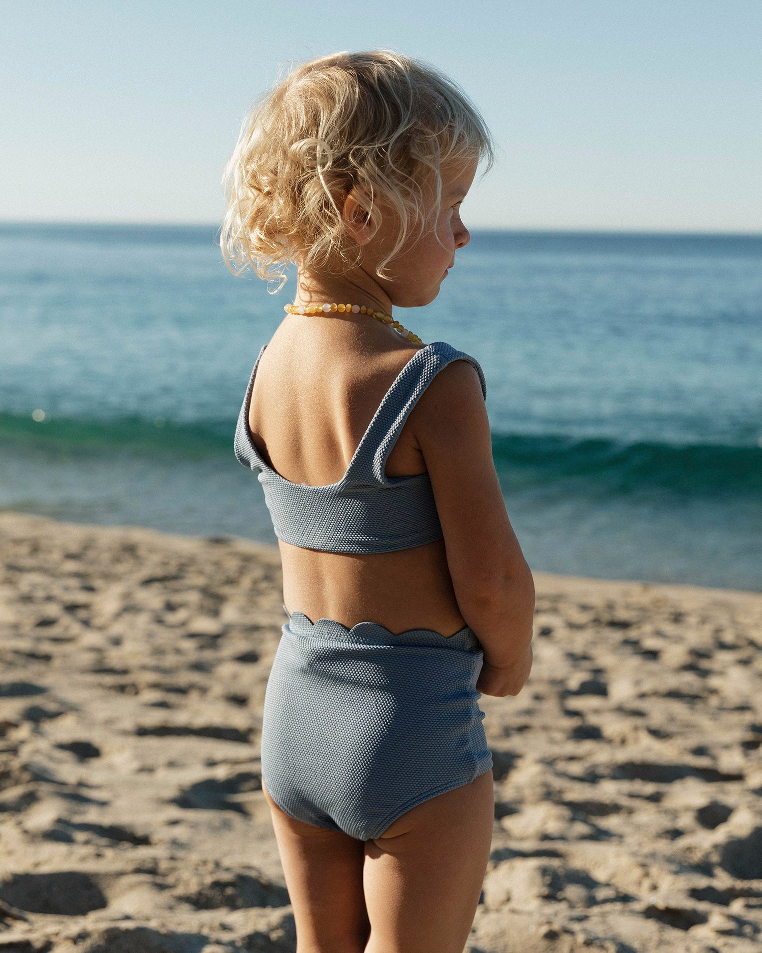 Seashell Swirl Set - Chambray LSPACE Seashell Swirl set in chambray, lifestyle/editorial view on model at the beach.