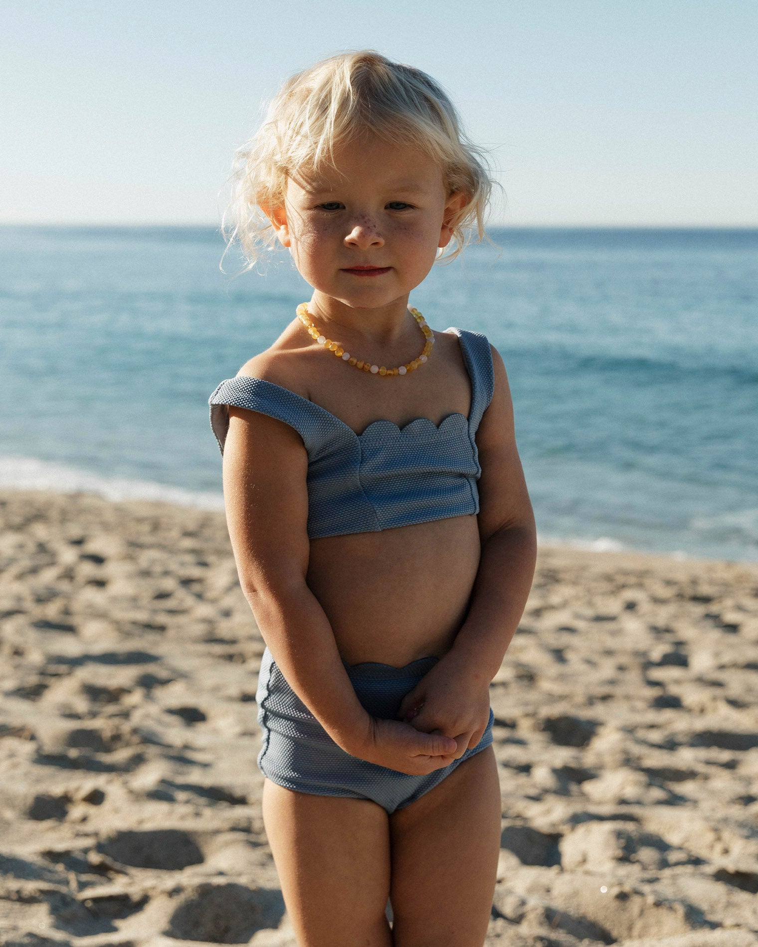 Seashell Swirl Set - Chambray LSPACE Seashell Swirl set in chambray, lifestyle/editorial view on model at the beach.