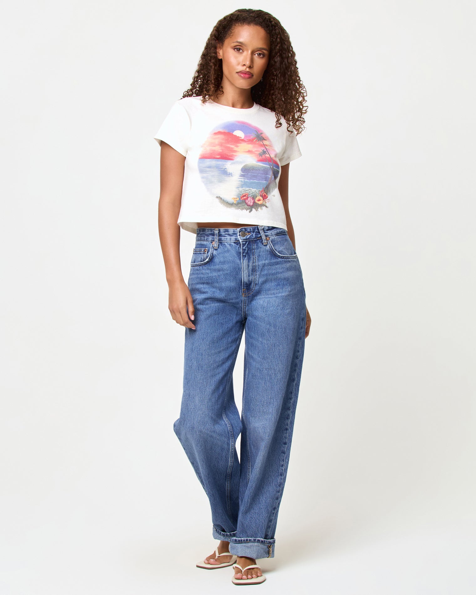 Merci Baby Tee - Airbrush Tourist Tee LSPACE Merci Baby Tee in airbrush tourist tee graphic, front view on model styled with jeans.