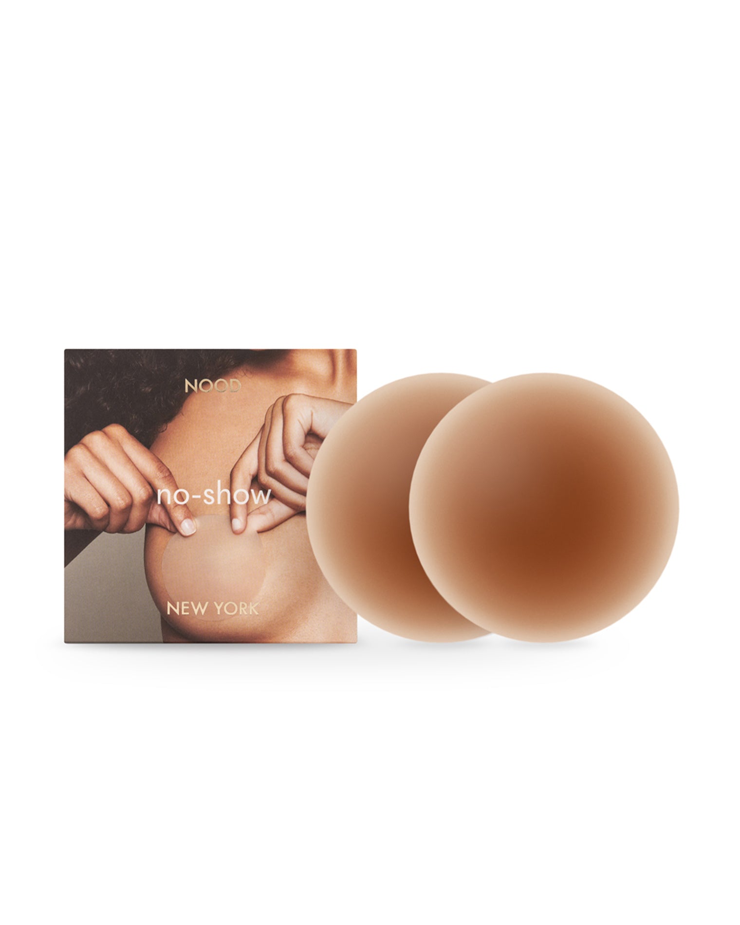NOOD No Show Adhesive Nipple Covers - Bronze Off-model image of the NOOD No Show Adhesive Nipple Covers in bronze with the NOOD branded packaging box.