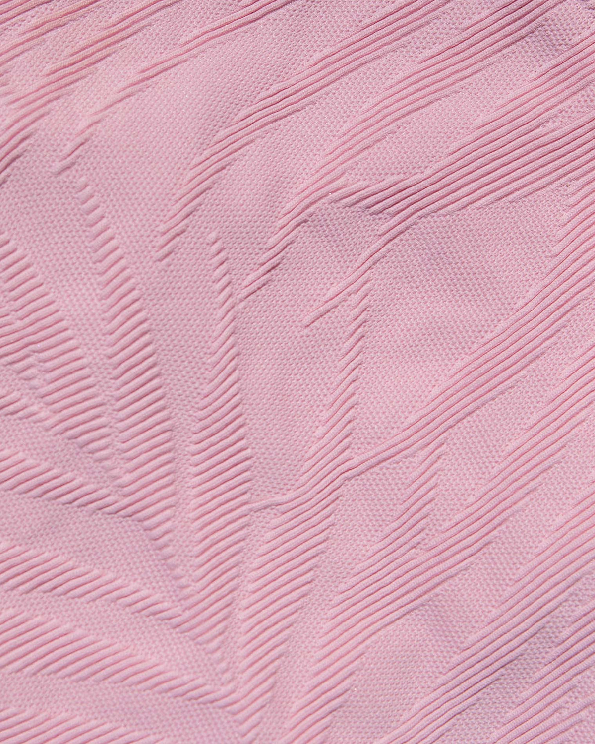 Bardot Bikini Bottom - Pink Sugar A close-up of light pink textured fabric with a raised leaf-like pattern.