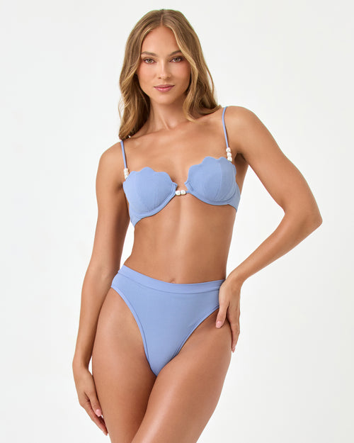 Front view of a model wearing the LSPACE chambray Sunrise Shell Bikini Top styled with the Frenchi Bikini Bottom.