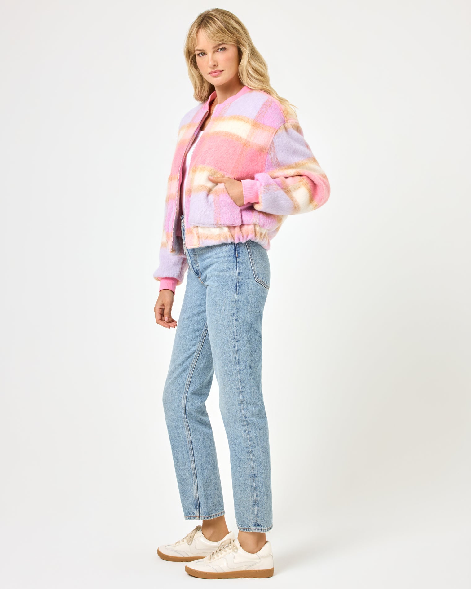 Quinn Jacket - Point Dume Plaid Side view of a model wearing the LSPACE Quinn Jacket in point dume plaid, showing the fuzzy plaid texture and relaxed bomber silhouette with ribbed cuffs, paired with wide-leg jeans.