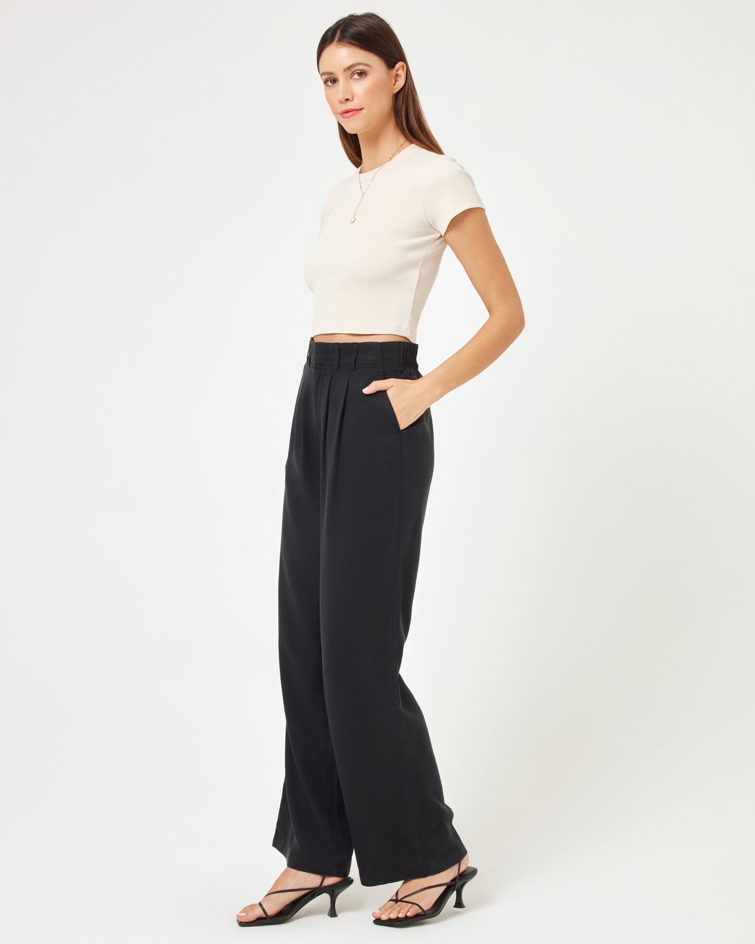 Rhodes Pant - Black Side view of model wearing the Rhodes Pant in black paired with a basic white tee.