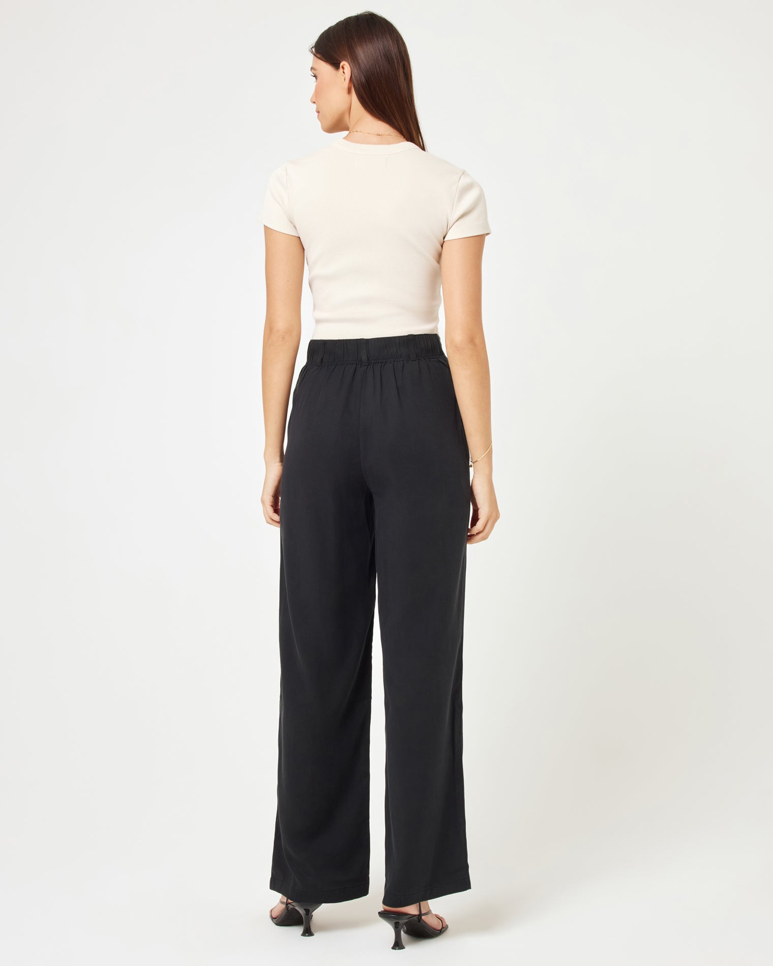 Rhodes Pant - Black Back view of model wearing the Rhodes Pant in black paired with a basic white tee.