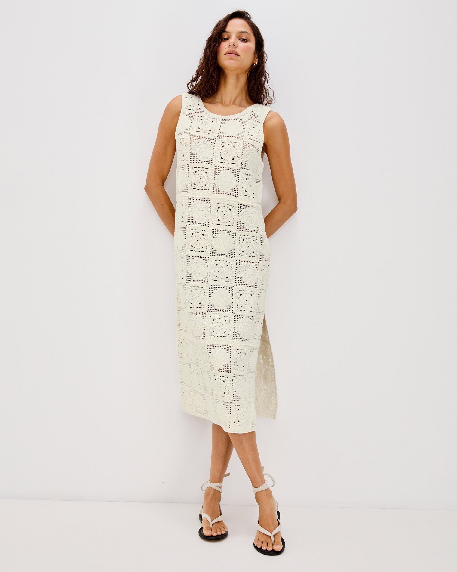 Calla Dress Front view of a model wearing the LSPACE Calla Dress in cream, displaying the full-length crochet silhouette with a side slit at the hem.