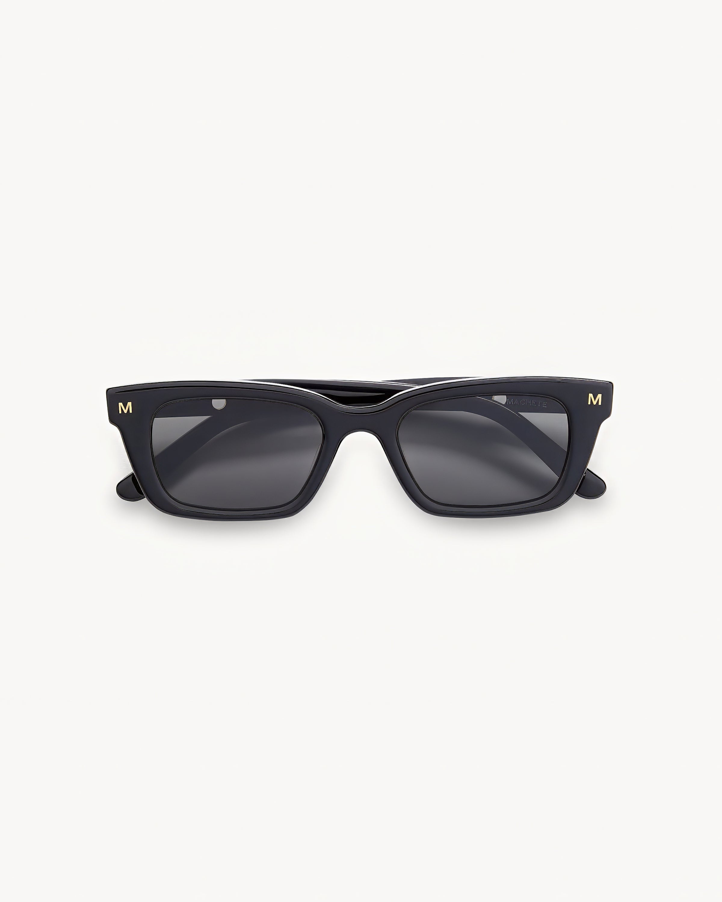 Machete Ruby Sunglasses - Black Off-model image of the Machete Ruby Sunglasses in black, folded flat with a black acetate rectangular frame and dark grey lenses.