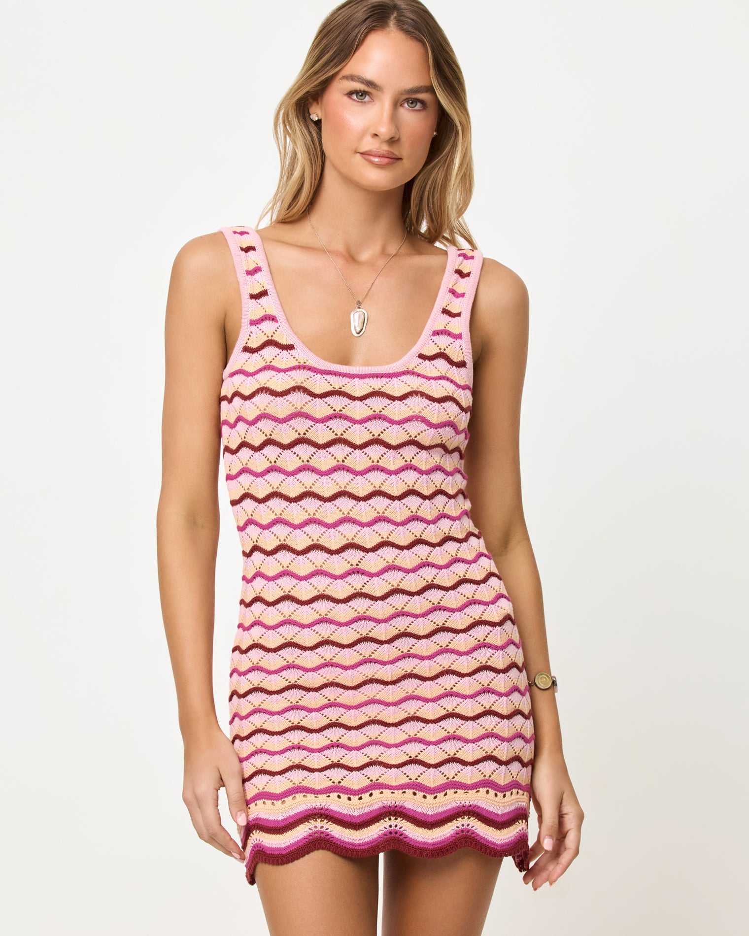 Sunchaser Dress - Berry Spritz Close-up front view of model wearing the LSPACE Sunchaser Dress in berry spritz showing the wave crochet pattern and scoop neckline.