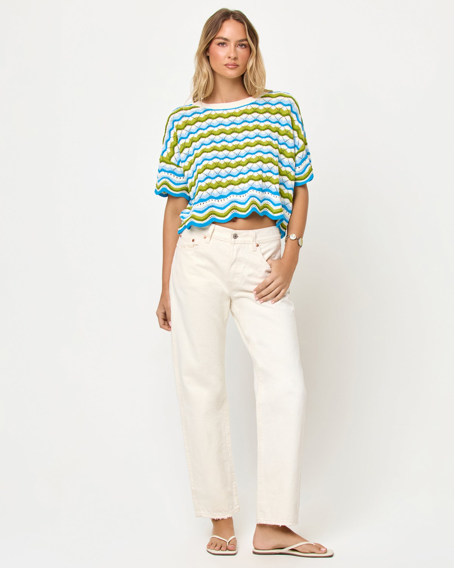 Sunchaser Top - Island Breeze LSPACE Sunchaser top in Island Breeze, front view on model styled with white pants.
