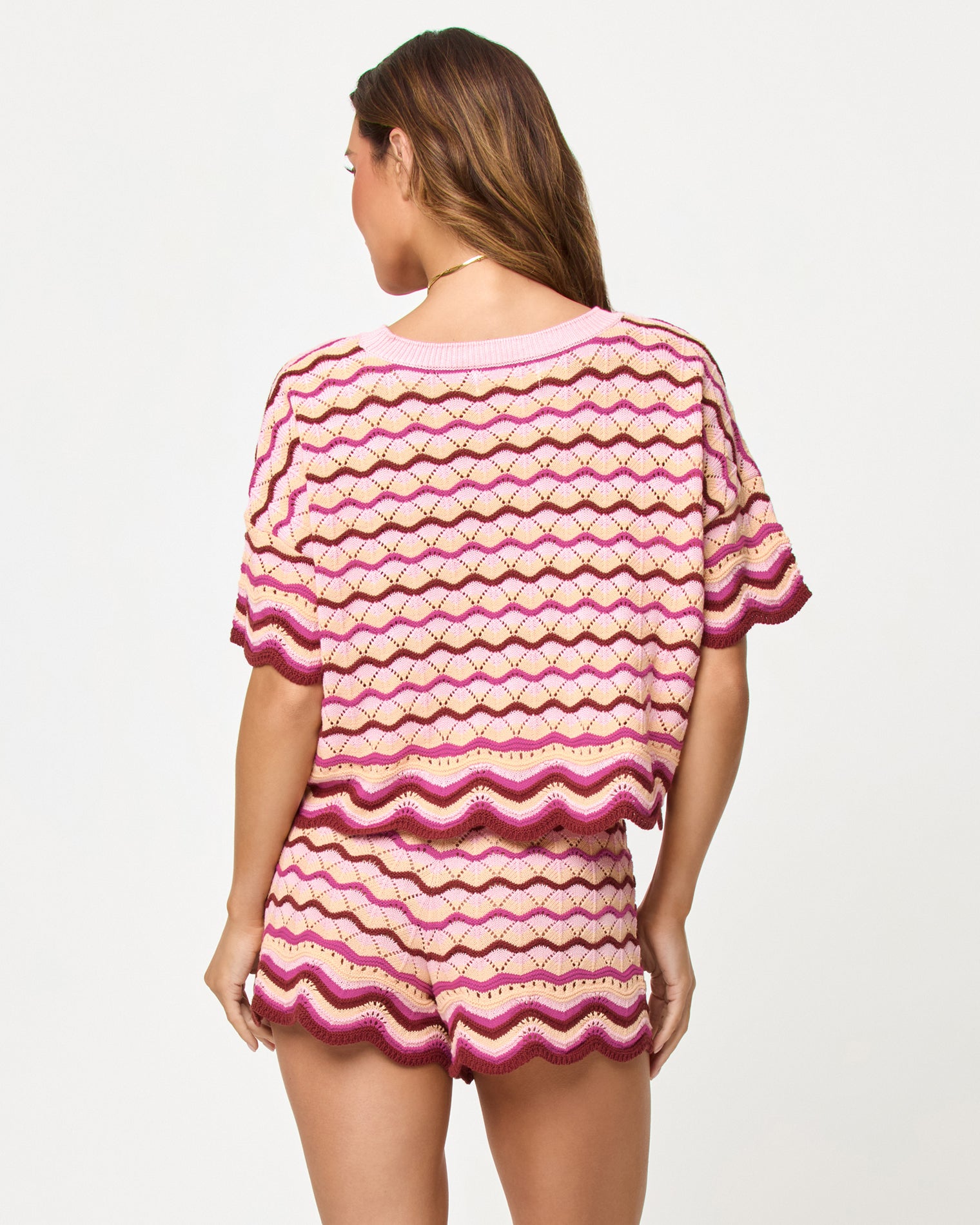 Sunchaser Short - Berry Spritz Back view of model wearing the LSPACE Sunchaser Top and Short in berry spritz, a crochet mini short with scalloped hem.
