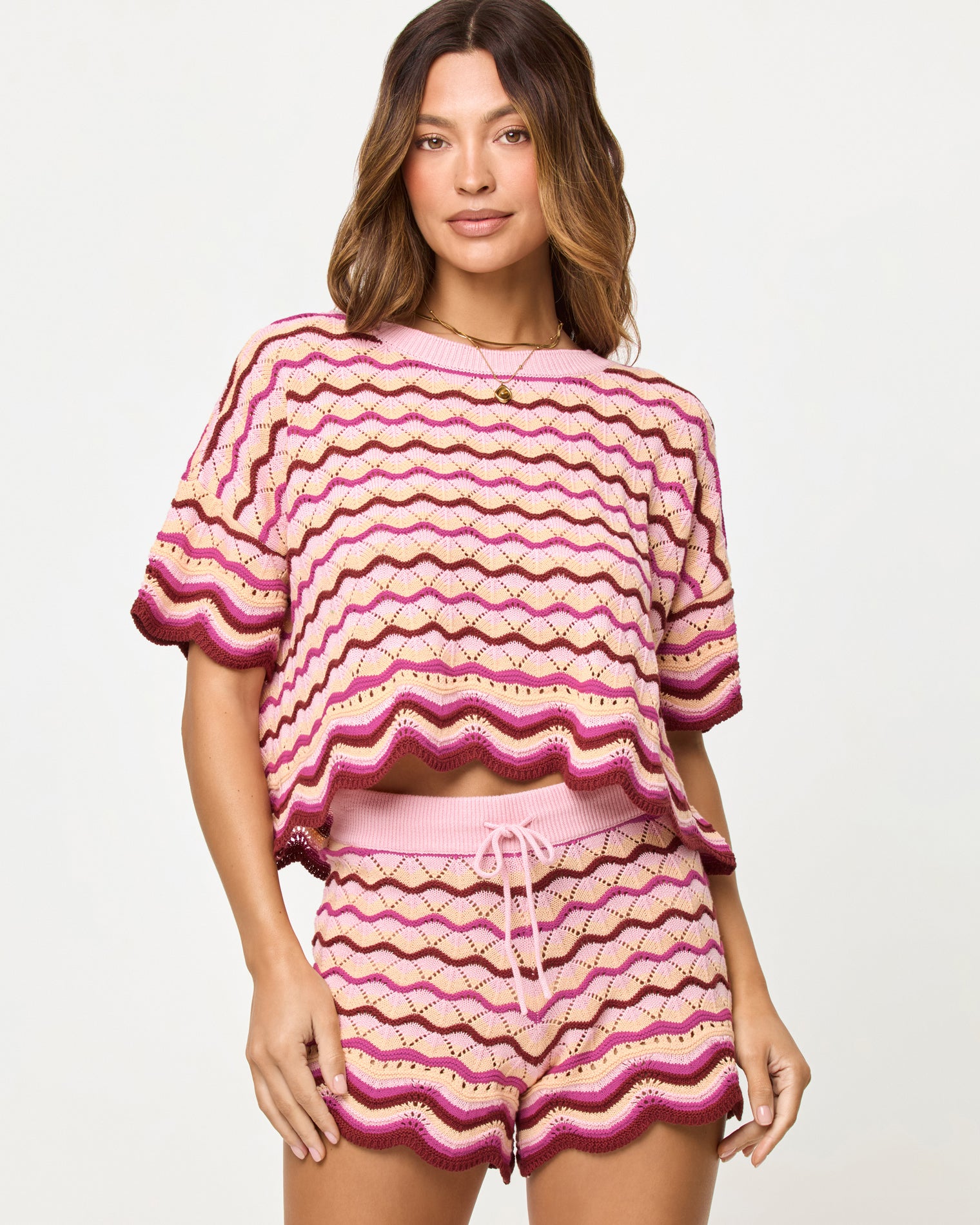 Sunchaser Short - Berry Spritz Berry Spritz | Badge:New Arrival_#B2AC88_#ffffff'
Close-up front view of model wearing the LSPACE Sunchaser Top and Short in berry spritz showing the wave crochet pattern and scalloped hem detail.
