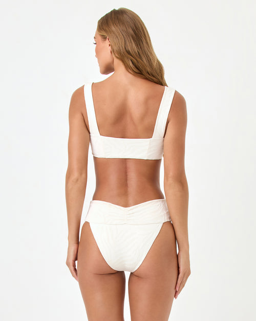 Back view of a model wearing the LSPACE cream Marlee Bikini Top, paired with the Bardot Bikini Bottom.