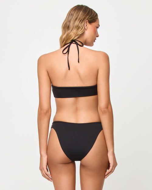 Back view of a model wearing the LSPACE Black Vega Bikini Bottom with a matching bralette top.