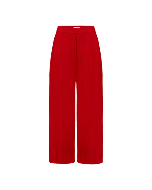 Off-model view of the LSPACE x The Salty Blonde Sur Pant in flame-cream, displayed flat to show the wide-leg silhouette and gathered waistband in flame red.