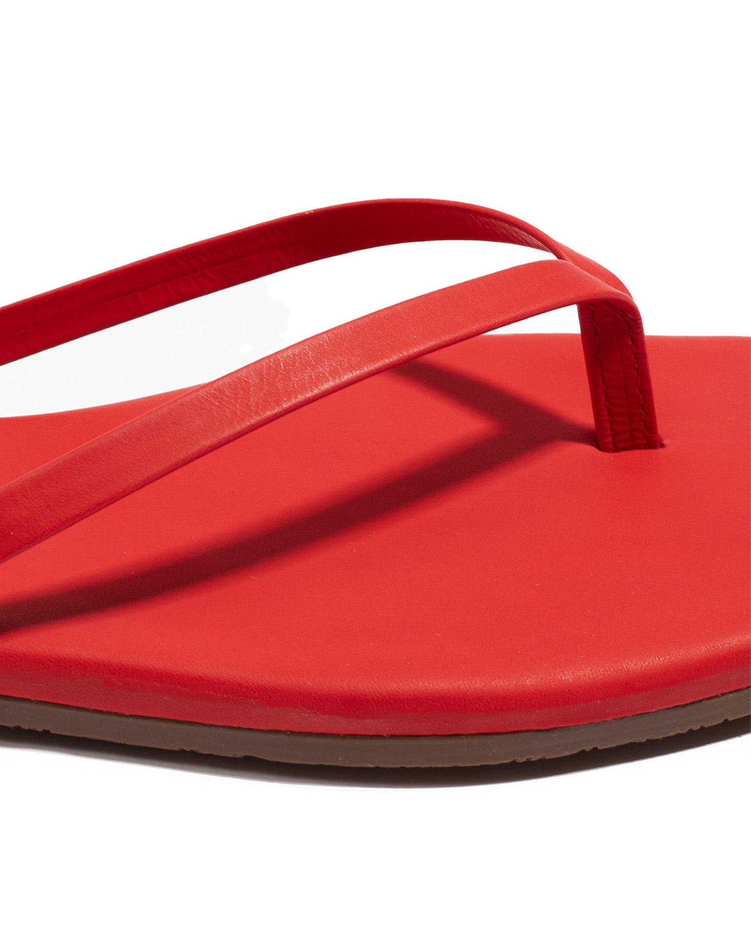TKEES Square Toe Lily Sandals - Red Close-up of the TKEES Square Toe Lily Sandals in red showing the strap and footbed detail.