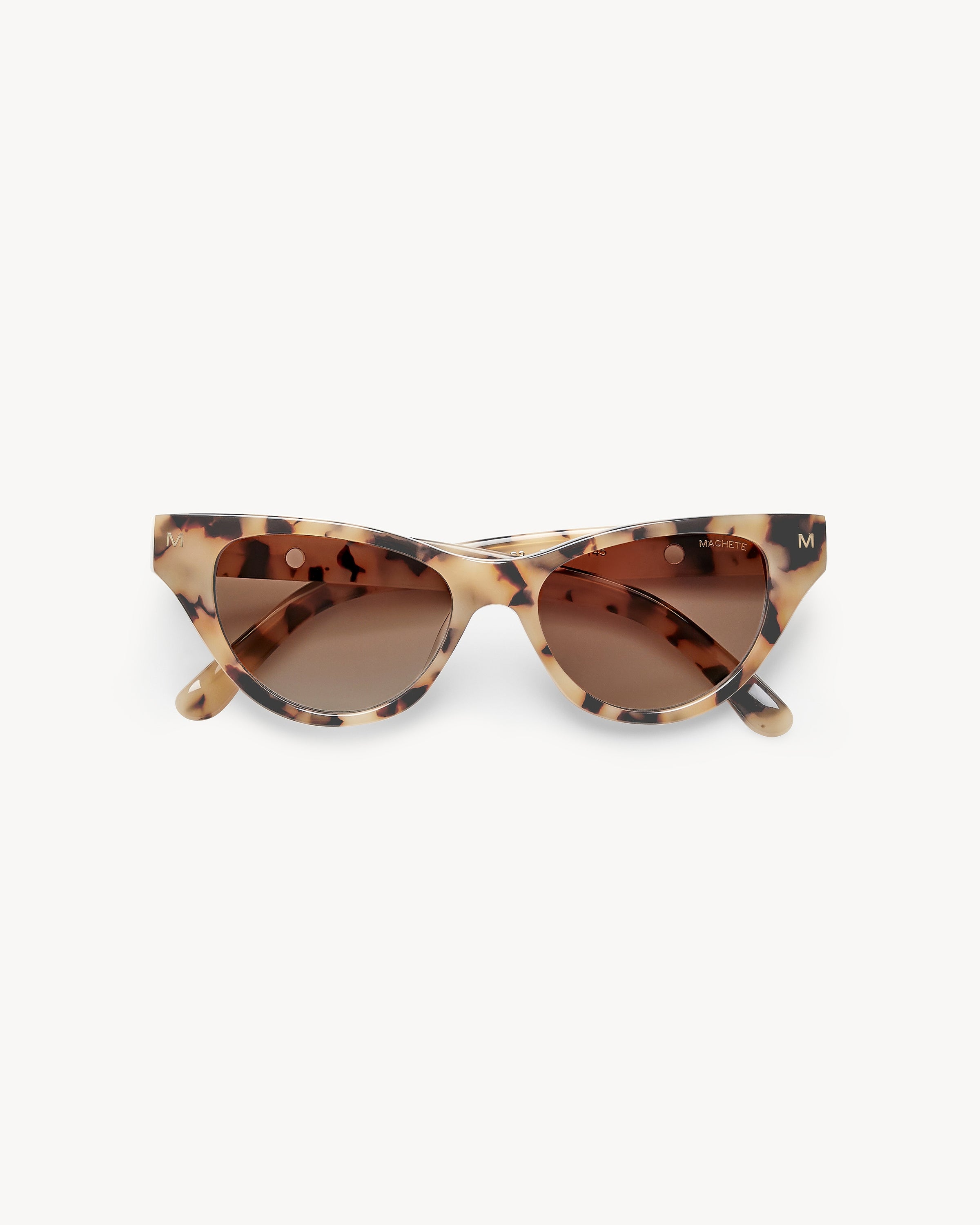 Machete Suzy Sunglasses - Blonde Tortoise Off-model image of the Machete Suzy Sunglasses in blonde tortoise, folded flat with cat-eye blonde tortoise acetate frame and brown gradient lenses.