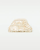 Front view of the Vienna Clutch in cream, showing a dome-shaped clutch covered in layered iridescent cream shell paillettes with a beaded top frame clasp.