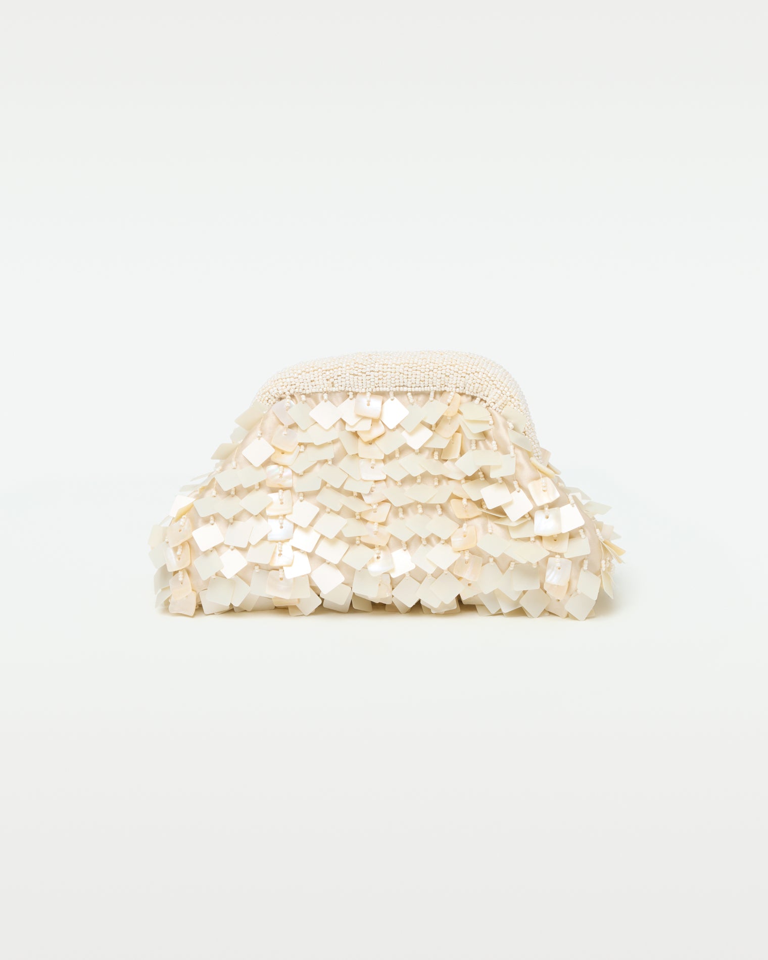Vienna Clutch - Cream Front view of the Vienna Clutch in cream, showing a dome-shaped clutch covered in layered iridescent cream shell paillettes with a beaded top frame clasp.