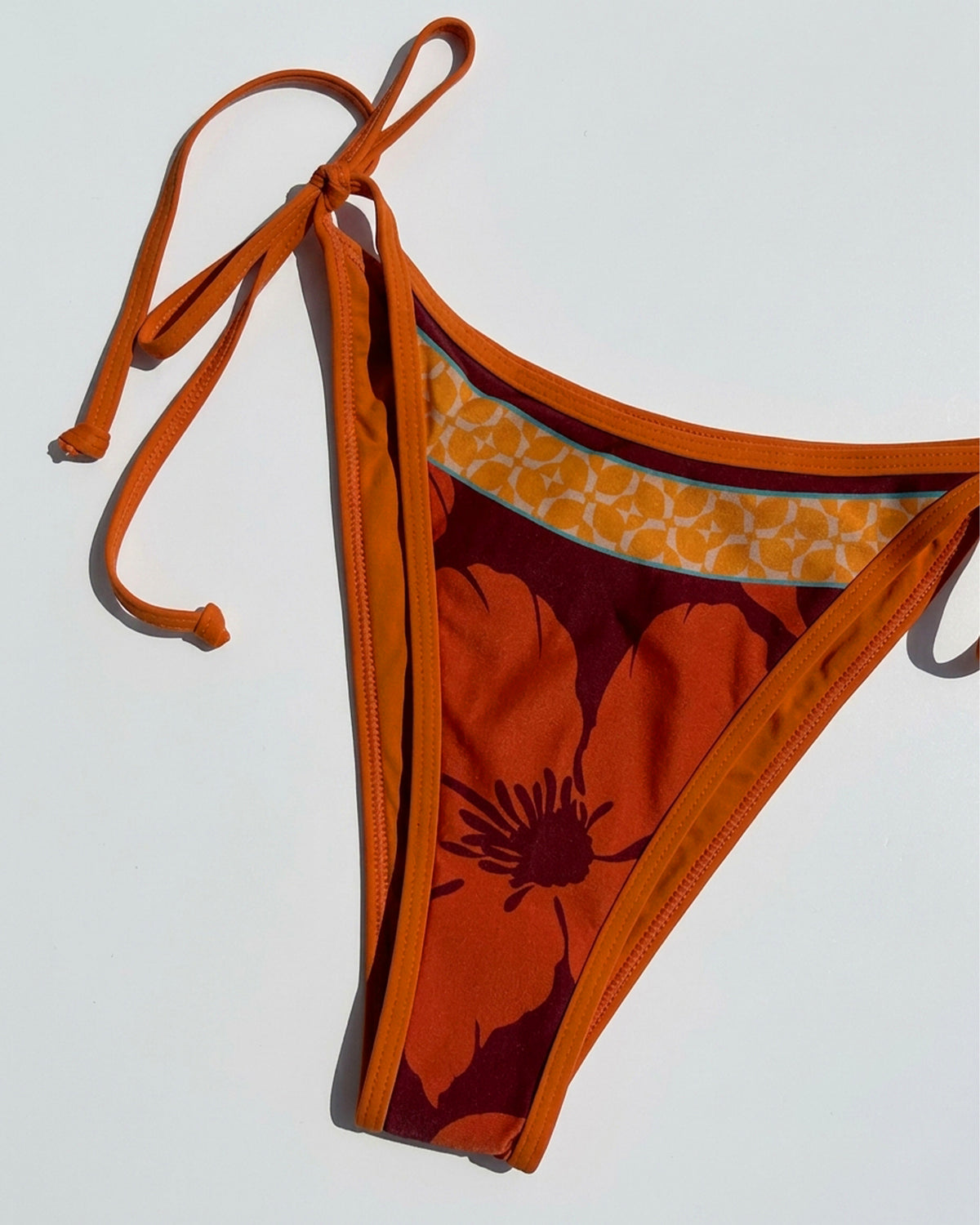 Levy Bikini Bottom - Cocobolo Close up flat lay of the Levy bikini Bottom in Cocobolo.