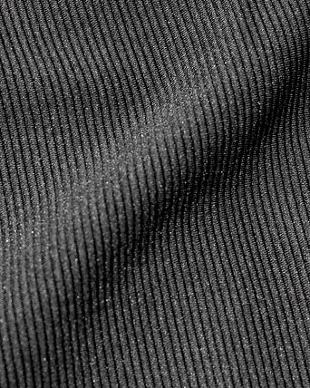 Kelly Bra - Black-Cream Close-up detail view of the LSPACE Kelly Bra in black-cream, highlighting the fabric texture and black-and-cream trim construction of the sports bra.