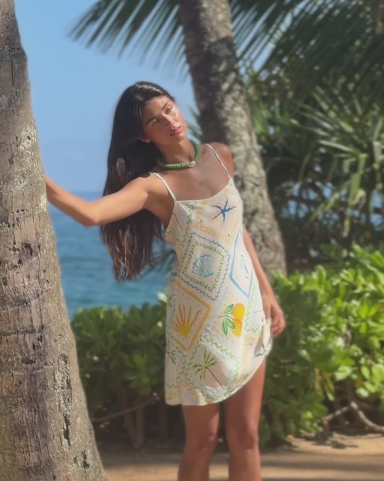 Gabby Mini - Wish You Were Here Video of model wearing the Gabby mini dress posing by an ocean view.