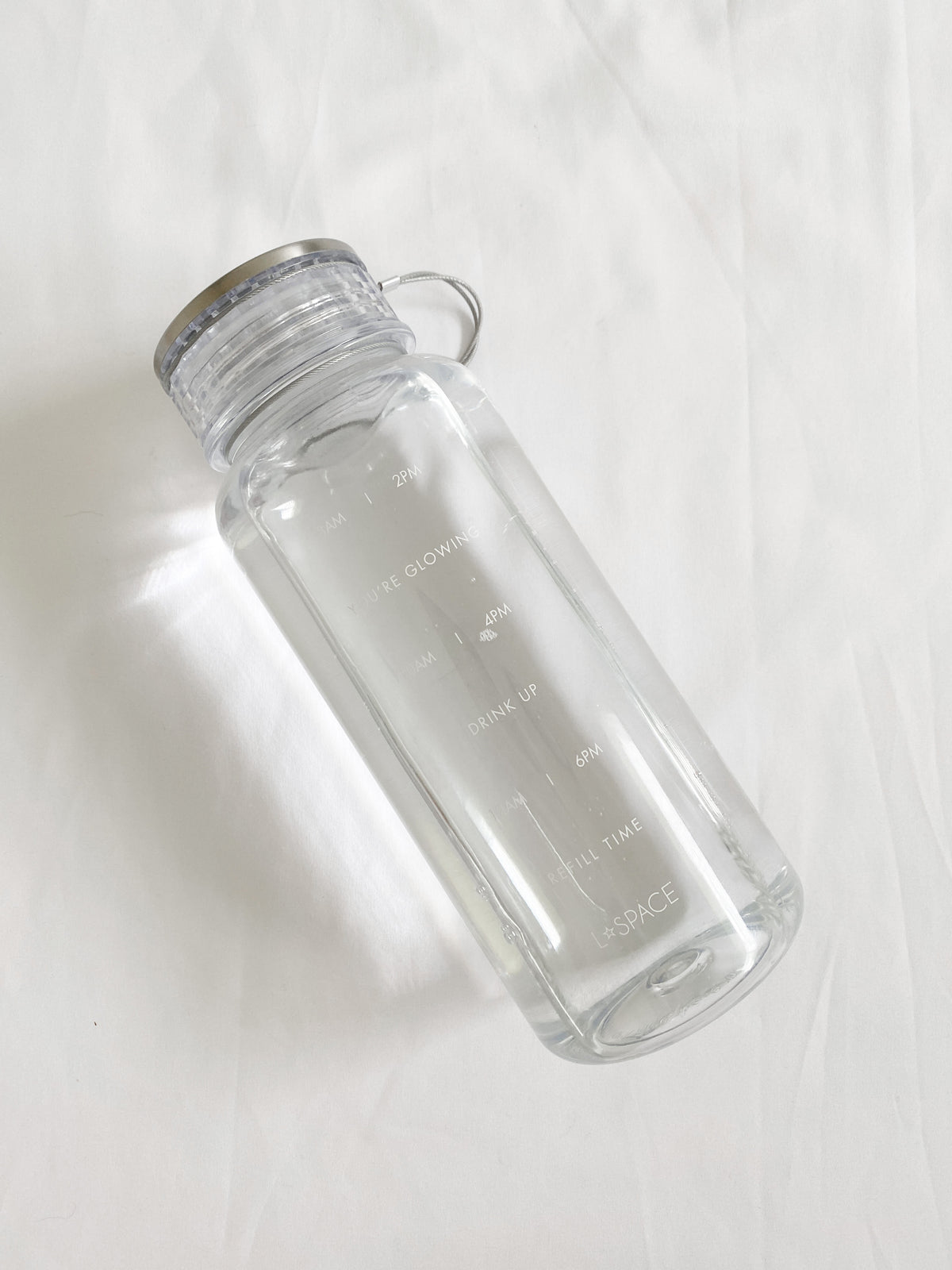 LSPACE Water Bottle LSPACE water bottle with wellness quotes, off-model flat lay.