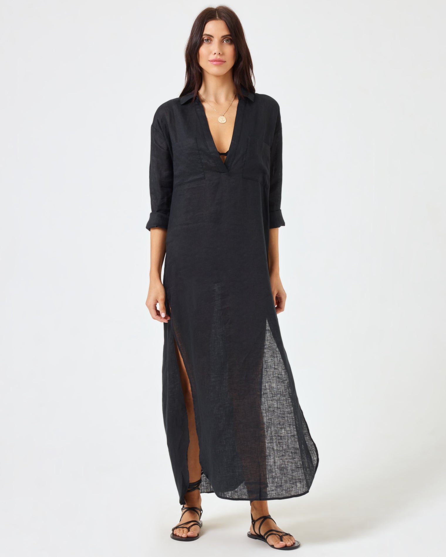 Capistrano Tunic - Black Front view of a model wearing the LSPACE Capistrano Tunic in black, a sheer linen maxi with a deep V-neck collar.