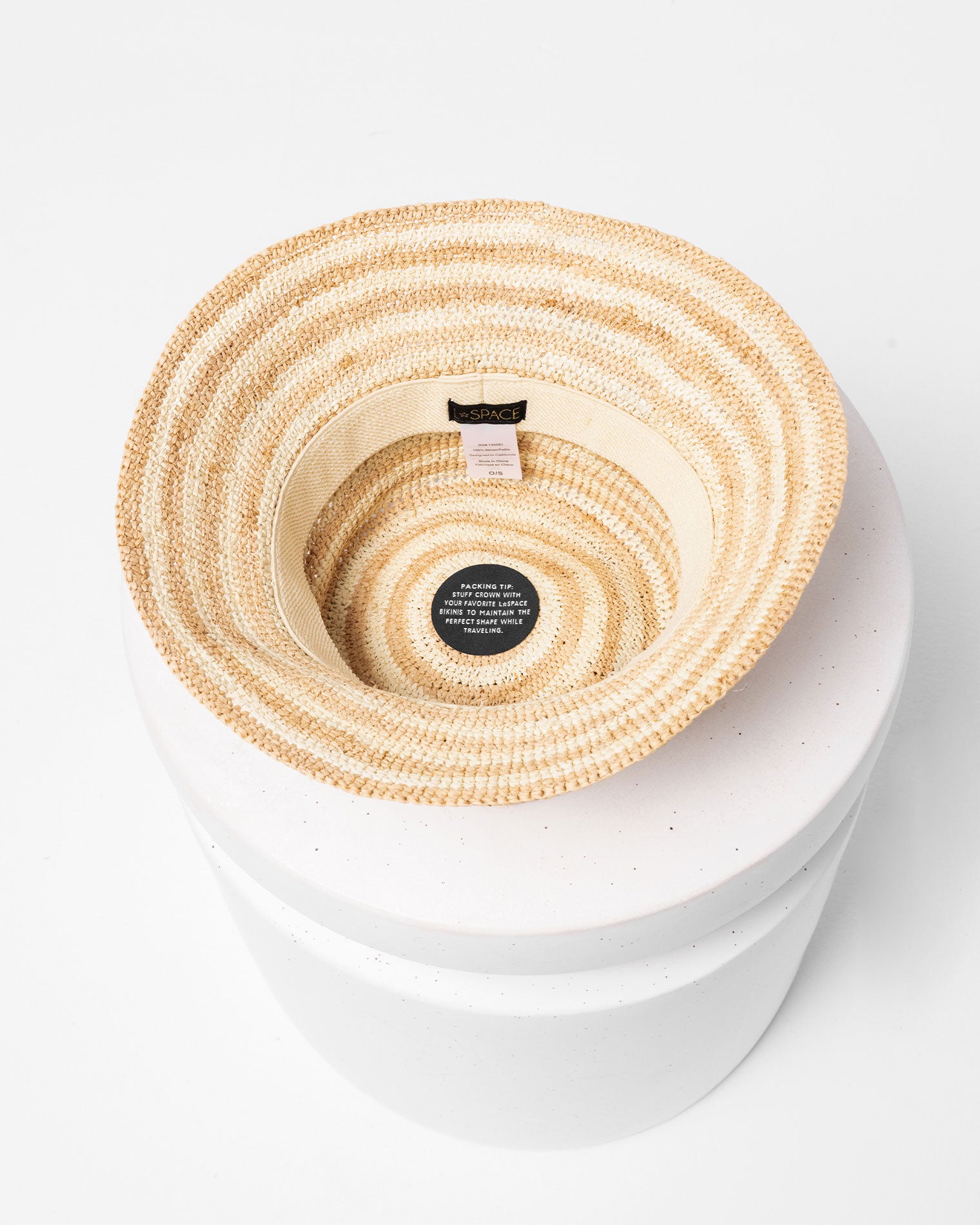 Isadora Bucket Hat - Stripe Top-down interior view of the Isadora Bucket Hat in stripe showing the stripe pattern inside, displayed on a white pedestal.