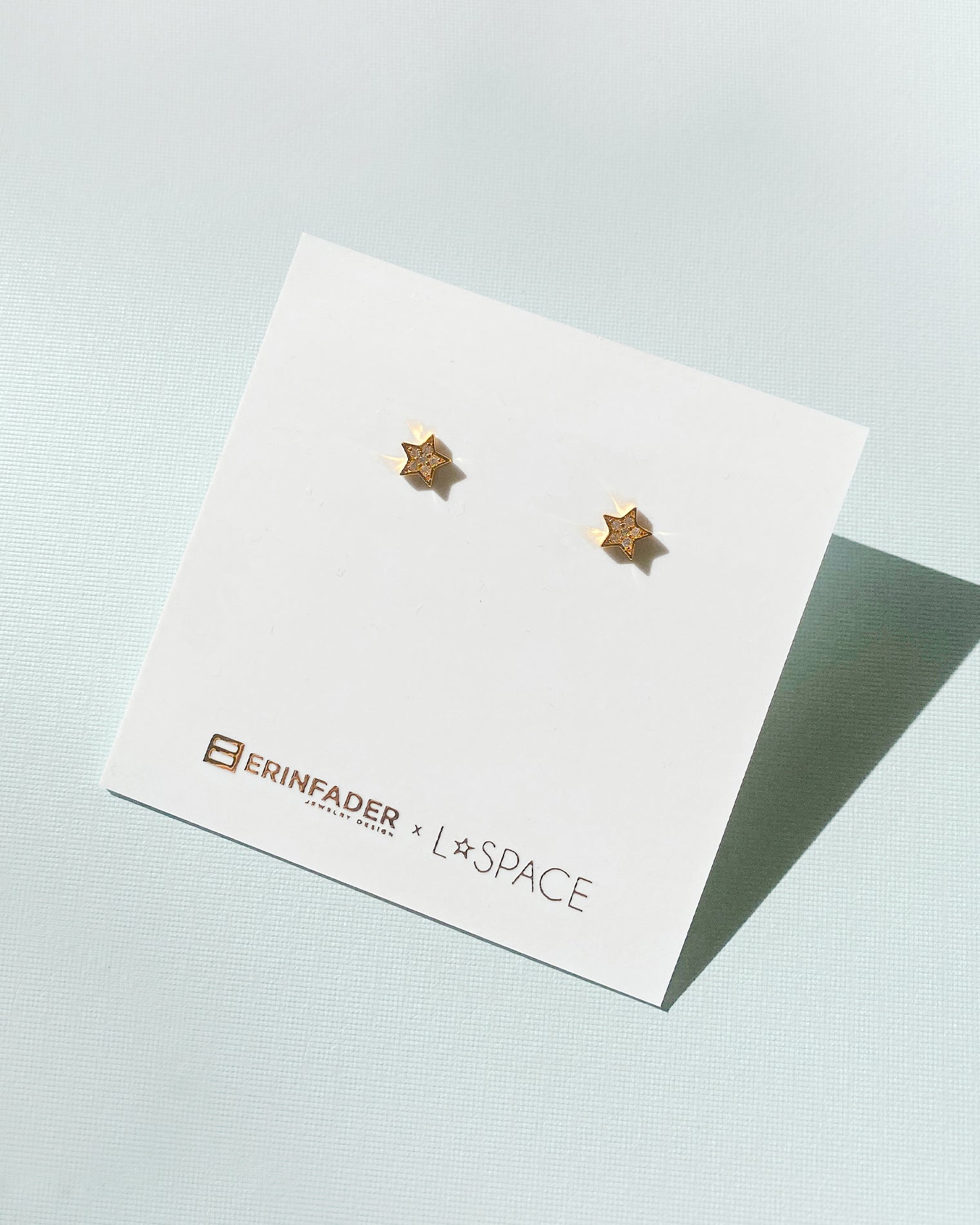 LSPACE x Erin Fader star stud earrings, off-model flat lay.