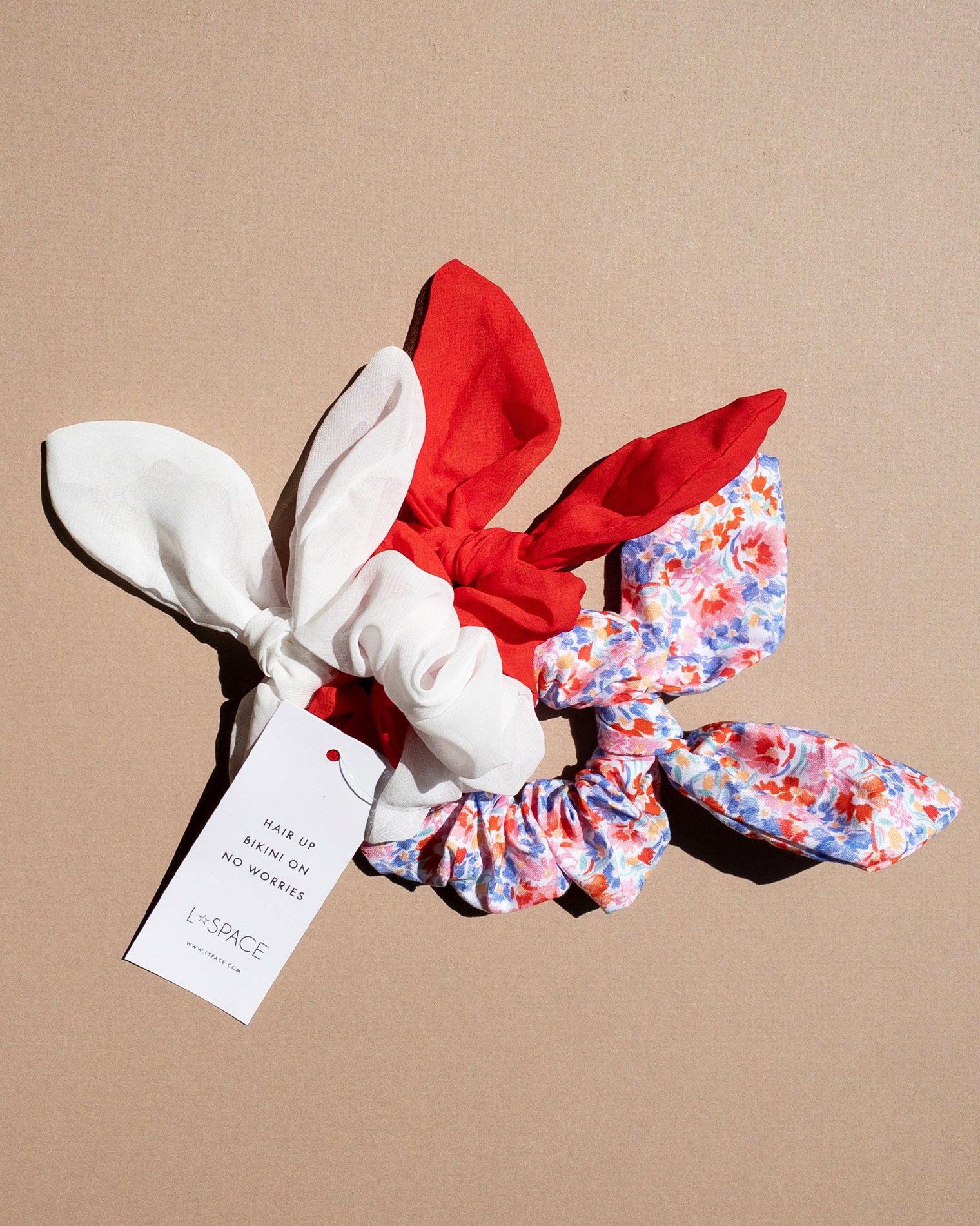 Scrunchie Set LSPACE Scrunchie Set in red, white, and floral print, off-model flat lay.
