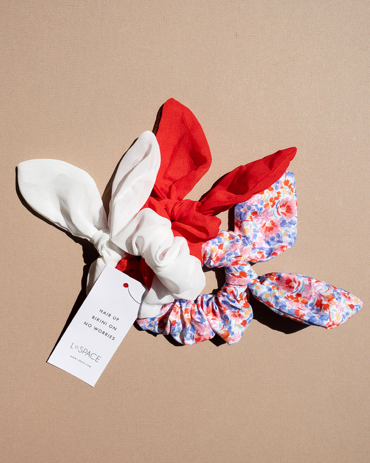 Scrunchie Set LSPACE Scrunchie Set in red, white, and floral print, off-model flat lay.