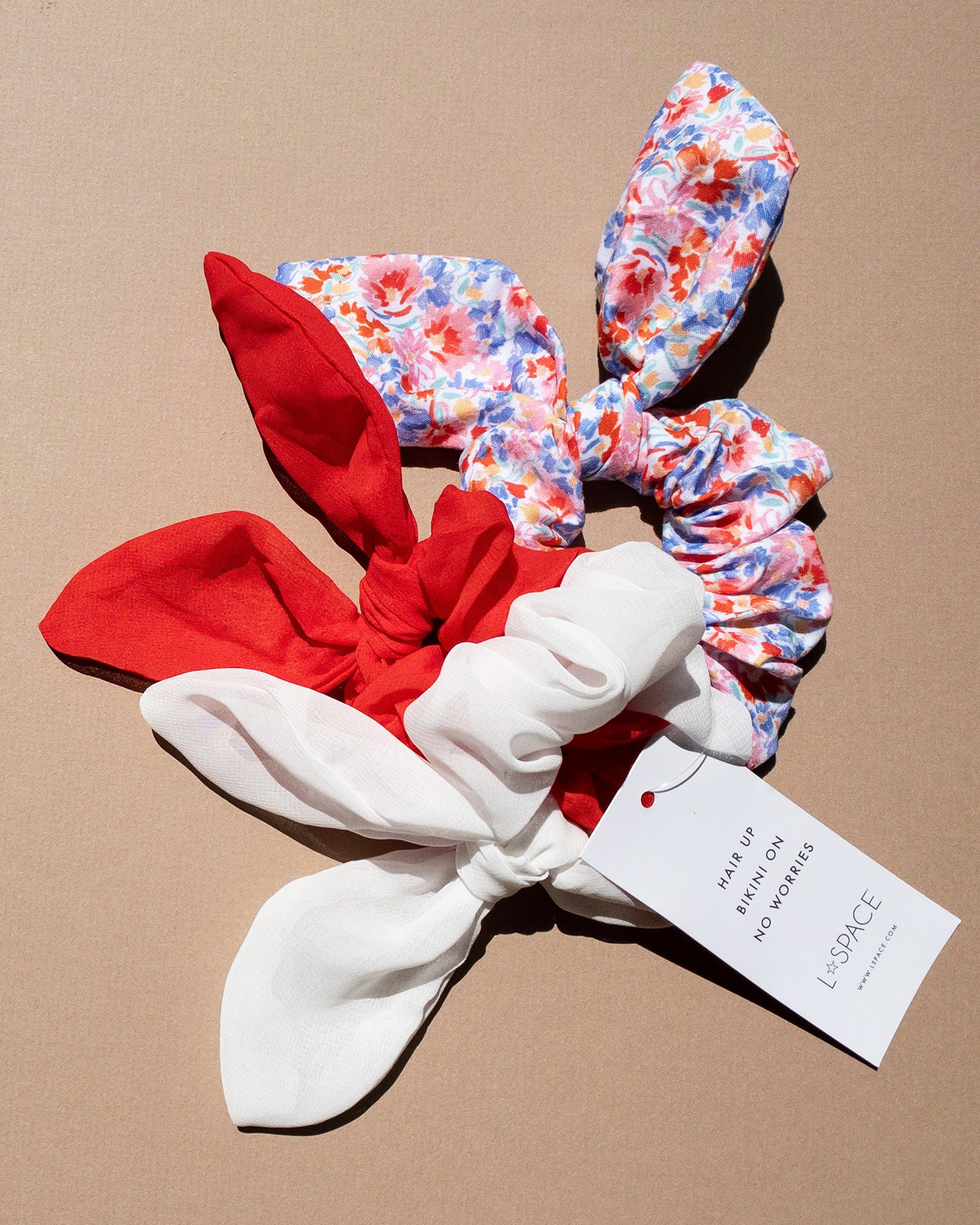 Scrunchie Set LSPACE Scrunchie Set in red, white, and floral print, off-model flat lay.