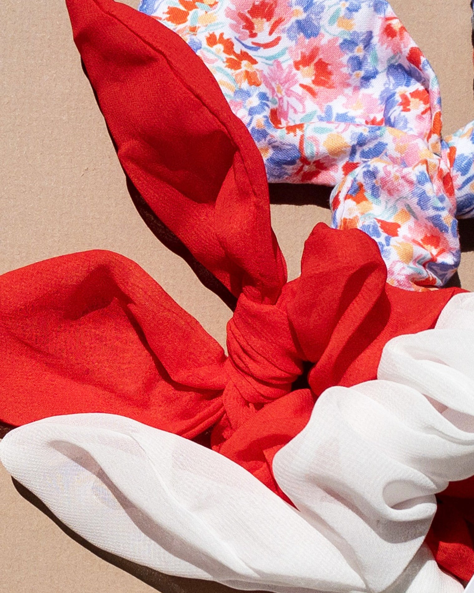 LSPACE Scrunchie Set in red, white, and floral print, off-model flat lay.